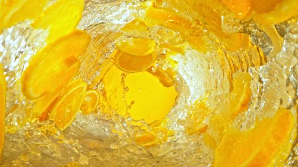 Texture of splashing water with orange slices. Abstract beverage background, freeze motion.