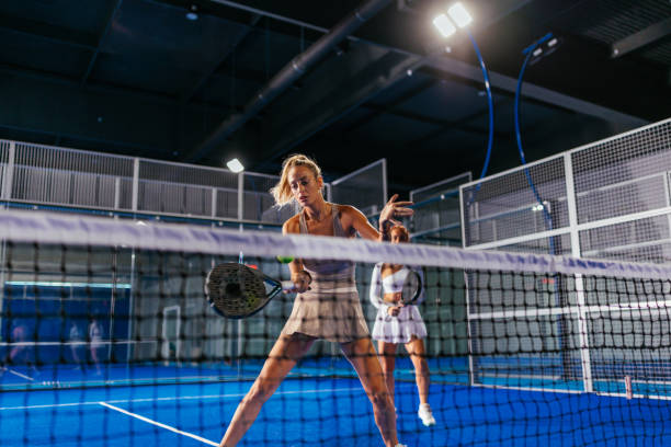 istock Female padel player hitting a shot during a doubles match 2188049672
