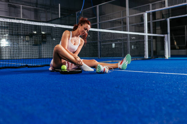 istock Female padel player holding her foot on the ground 2188049676