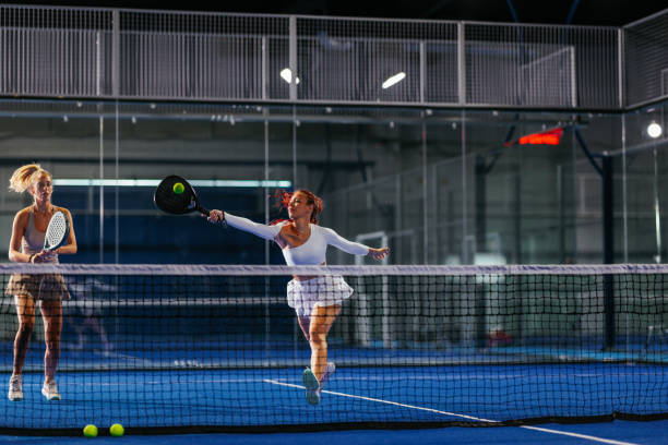 istock Female padel player in white at the net 2188049677