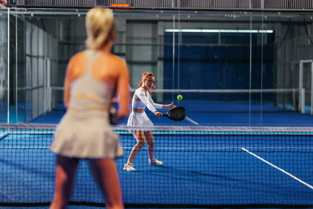 istock Redhead female padel player playing a backhand during a singles match 2188049682