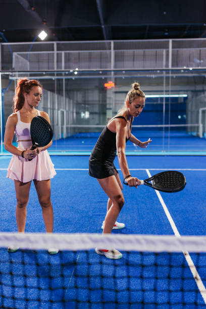 istock Female padel coach showing how to hit a backhand 2188049702