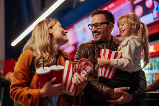 istock Joyful family purchasing popcorn and beverage in cinema. 2188050363