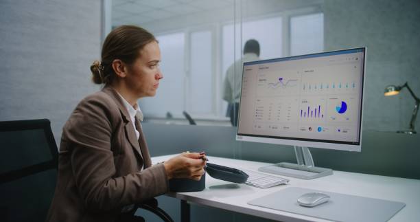 istock Female financial specialist eats food at workplace during lunch break 2188050759