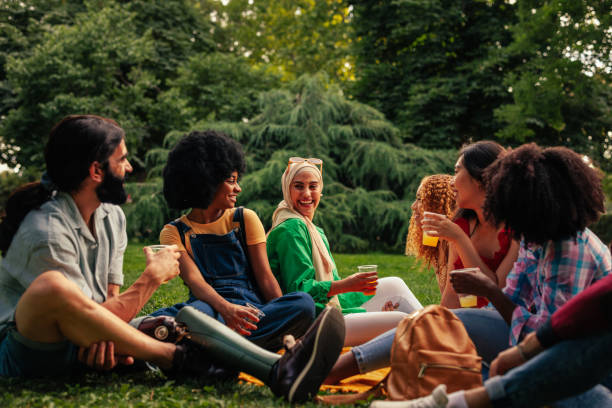 istock Friends on day time party in park 2188050842