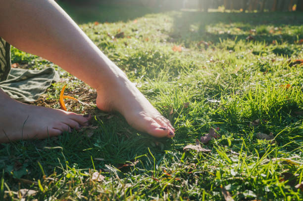istock Barefoot on Grass - Grounding - Earthing - Mexican Woman - Relaxing - Close Up 2188051262