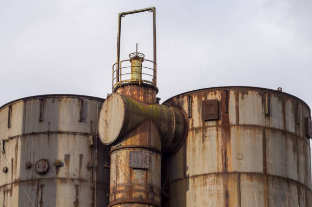 istock Rusty industrial tanks and pipes reaching for the cloudy sky 2188051334