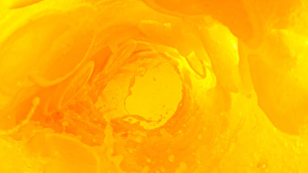 Splashing orange juice creating twister shape. Abstract fresh juicy beverages background with slices.