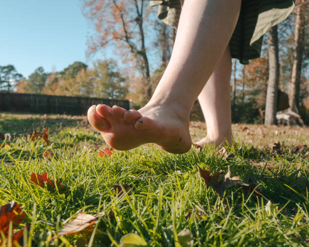 istock Barefoot on Grass - Grounding - Earthing - Mexican Woman - Low Angle Close Up - Walking 2188051992
