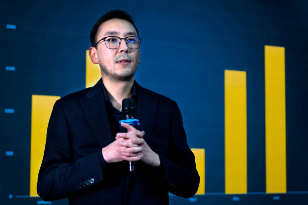 istock Journalist in eyeglasses holding microphone on the scene while press conference 2188052584