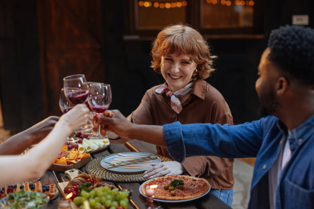 istock Cute redhead toasting with her friends at a dinner party 2188053040