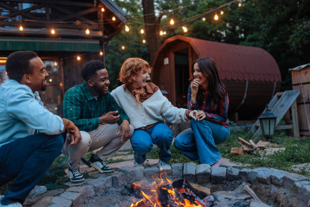 istock Group of friends laughing next to a backyard campfire 2188053060