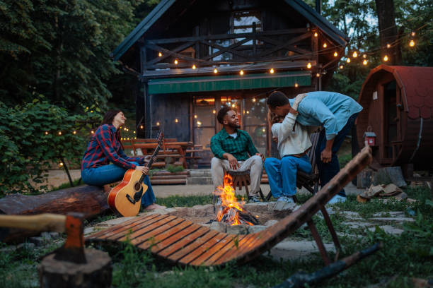istock Friends enjoying a campfire in front of a cabin 2188053063