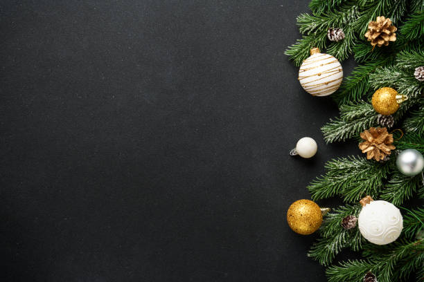 istock Christmas decorations and spruce tree at black background. 2188055847