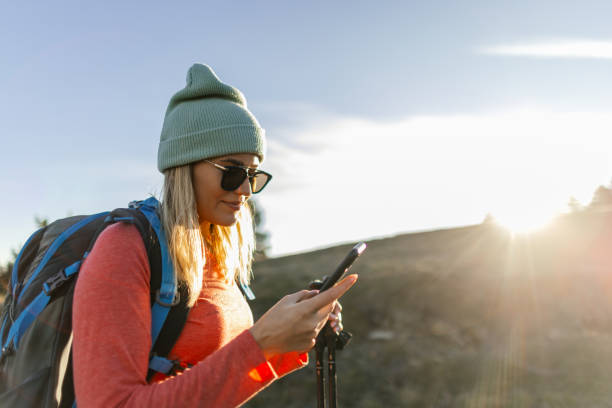 istock Woman looking at her phone while hiking in the mountains 2188057432