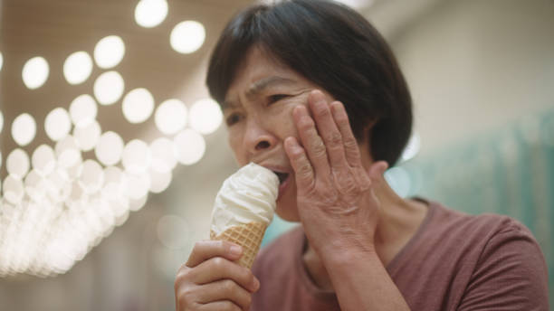 istock Mature woman have a toothache while eating ice cream. 2188058976
