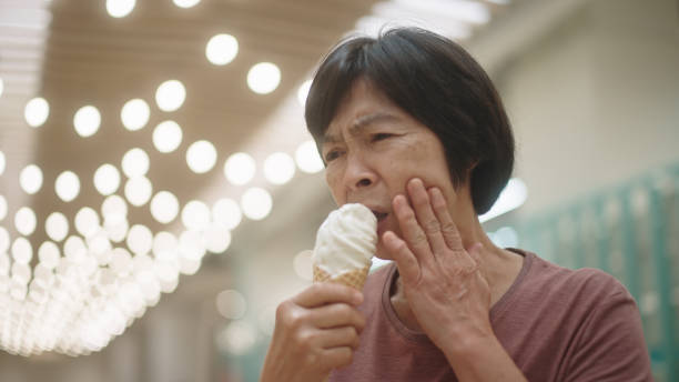 istock Mature woman have a toothache while eating ice cream. 2188058980