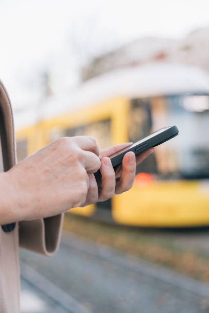 istock Businesswoman using smartphone while waiting for tram 2188059212