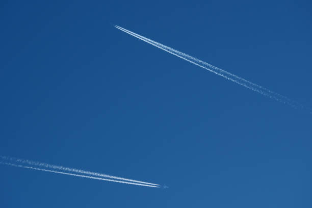 Airplane trails in the blue sky, 2 contrails
