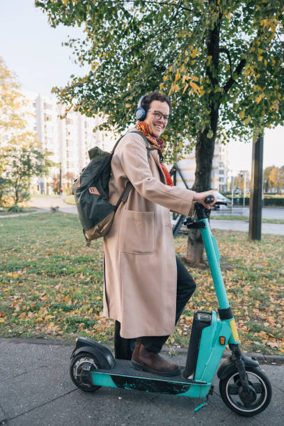 istock Young woman riding electric scooter to work in Berlin 2188059312