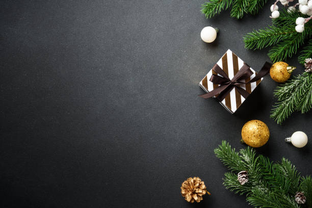 istock Black christmas background. Christmas flat lay with spruce tree present and decorations. 2188061137