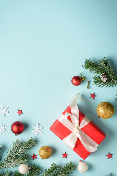 istock Blue christmas background. Christmas flat lay with spruce tree, present box and holiday decorations. 2188061273