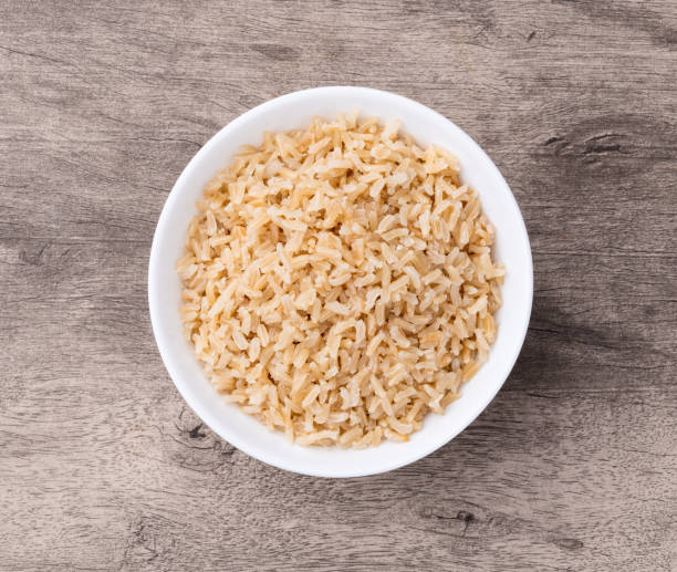istock Cooked brown whole rice in a bowl over wooden table 2188062373