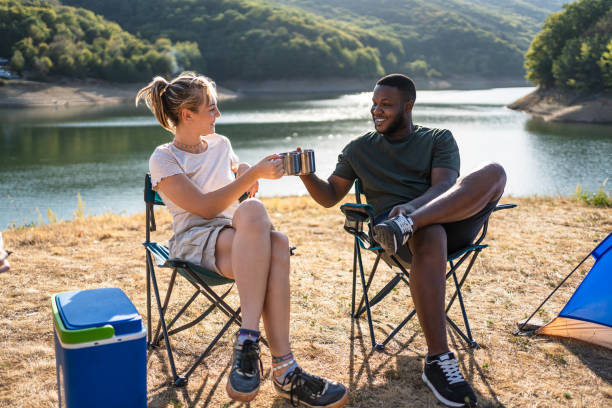 Friends enjoying camping by the lake together