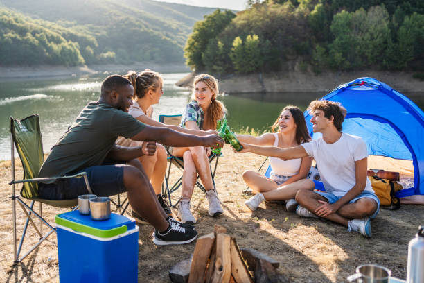 istock Friends toasting with beers while camping in front of a lake 2188065229
