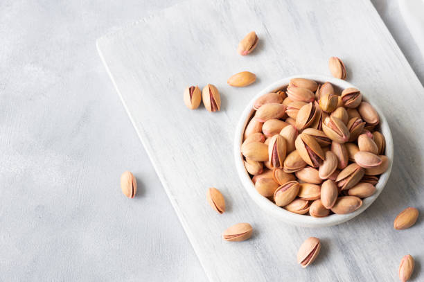istock Pistachio nut in nutshell on rustic backdrop in bowl, composition of pistachios great for healthy and dietary nutrition. Concept of nuts 2188066256