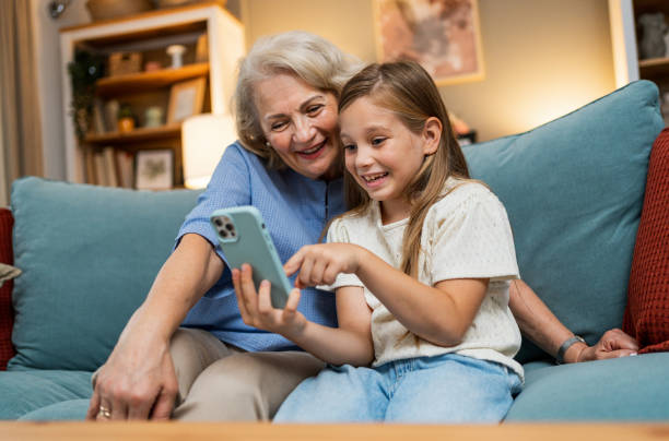 istock Grandma and granddaughter using phone together 2188068742