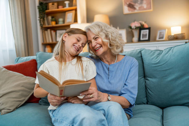 istock Grandmother with granddaughter reading book 2188068892