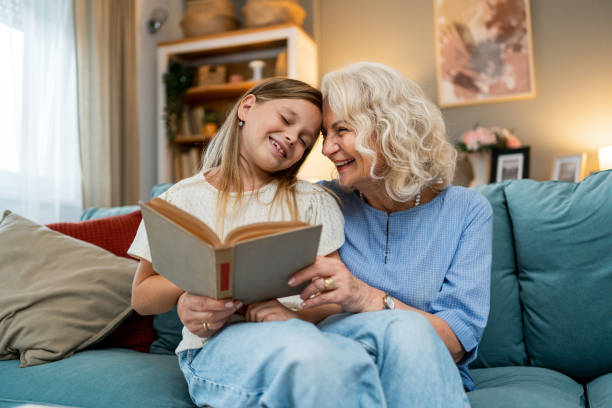 istock Grandmother with granddaughter reading book 2188068901