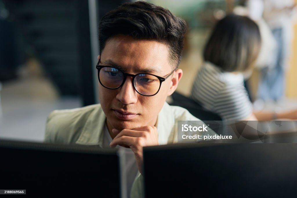 Young Asian Man Working As Software Developer Coding On Computer In ...
