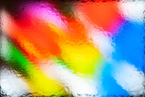 Blurred abstract background. Abstract image of colored spots through the wet glass. Water drops. Creative background