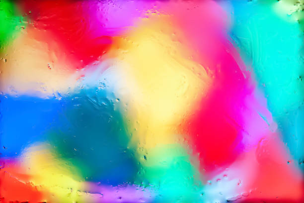 Blurred abstract background. Abstract image of multi-colored blurry spots through wet glass. Texture of traces of water and oil. Creative background