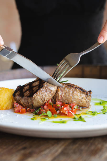 istock Veal medallions with fresh salad on a large white plate. 2188072426