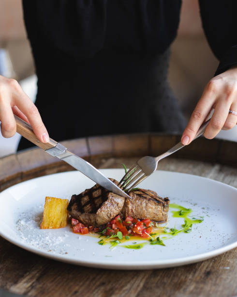 istock Veal medallions with fresh salad on a large white plate. 2188072430