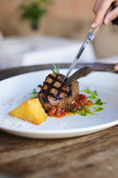 istock Veal medallions with fresh salad on a large white plate. 2188072470