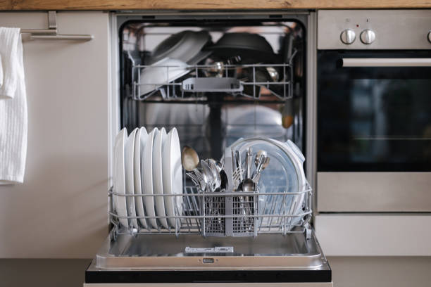 istock Open dishwasher with organized clean dishes, placed in a home kitchen. 2188075897