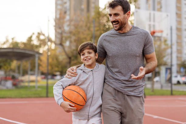 istock Basketball Bonding: Dad and Son Together on the Court 2188083037