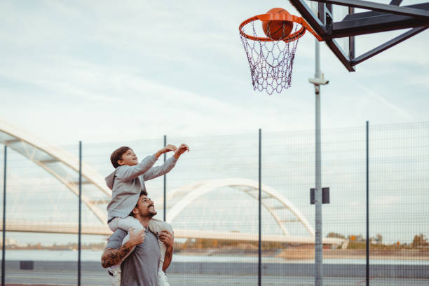 istock Together We Aim: Father Supporting Son’s Basketball Dream 2188083038