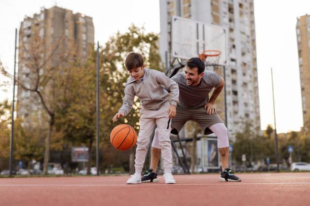 istock Basketball Bonding: Father and Son Playing Together Outdoors 2188083112