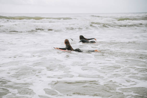 istock Two surfer friends in the sea 2188090978