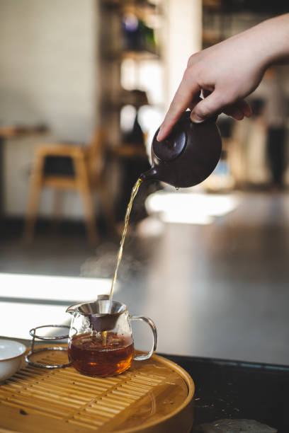istock Chinese traditional tea ceremony. Tea is pouring from the teapot 2188092519