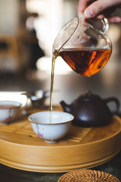 istock Chinese traditional tea ceremony. Tea is pouring from the teapot 2188092606
