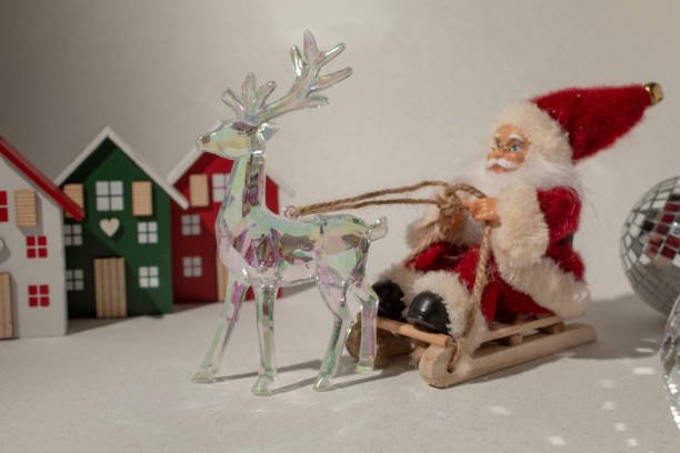 istock Santa Claus on a sleigh and glass reindeer. Minimal composition 2188097614