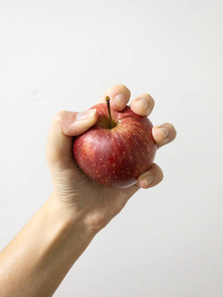 istock A hand holding a whole red apple in its palm 2188098898