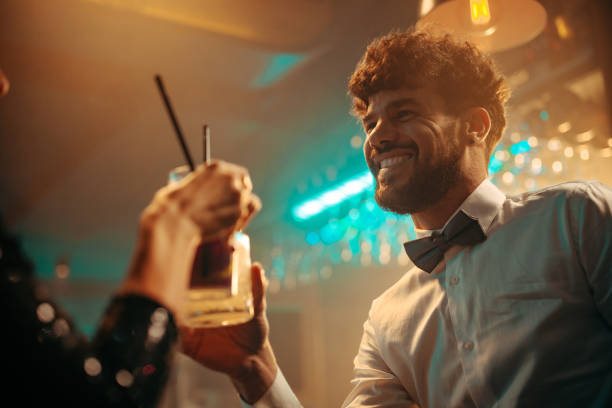 istock Man cheering with a woman at a bar 2188100427