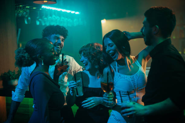 istock Friends laughing and dancing at a bar party 2188100433